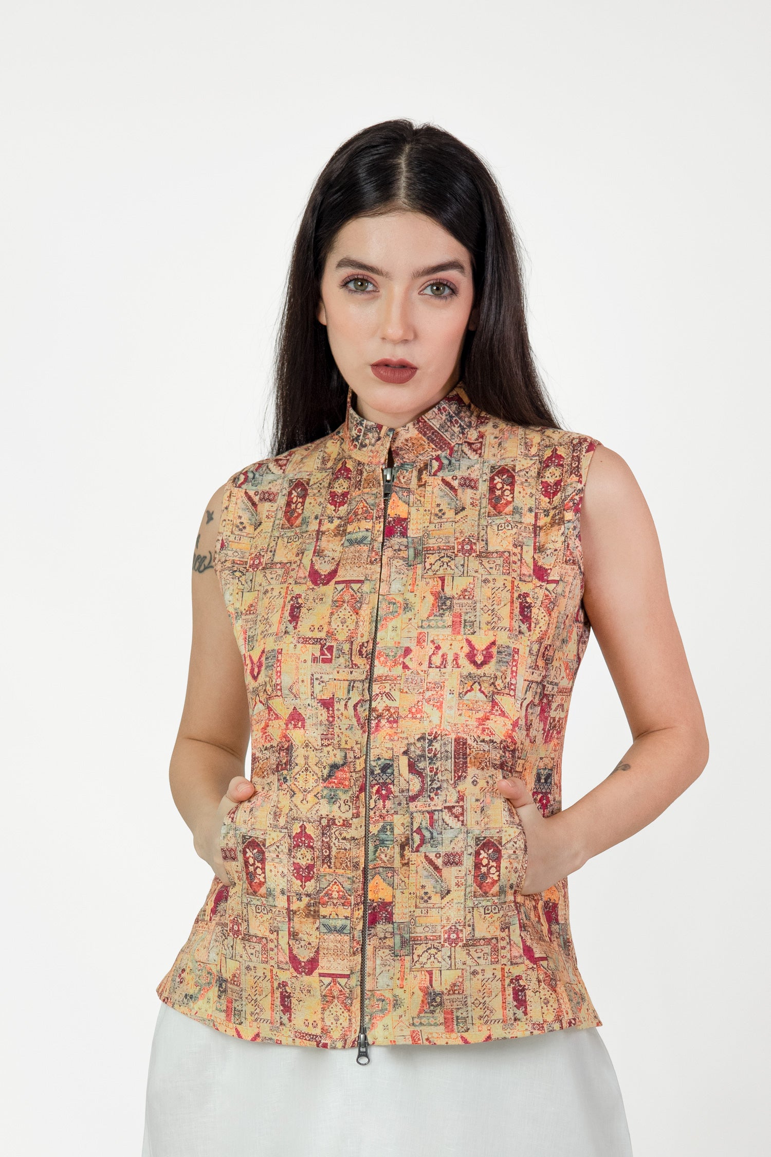 Woman wearing a patterned sleeveless top on a white background