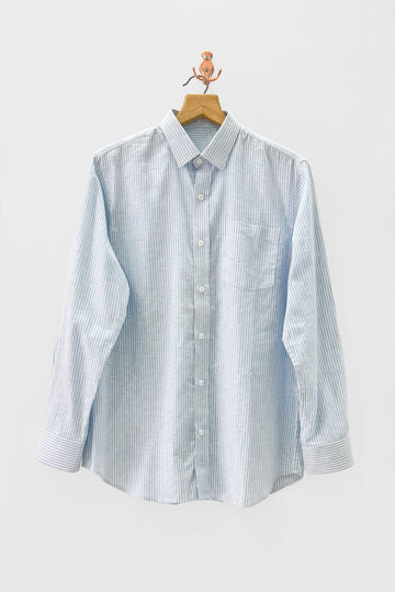 Light blue and white striped shirt on a hanger against a light gray background