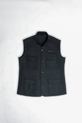 A black sleeveless button-front vest with a stand collar, laid flat on a light gray background. It features four front flap pockets and a small white embroidered logo on the upper right chest.