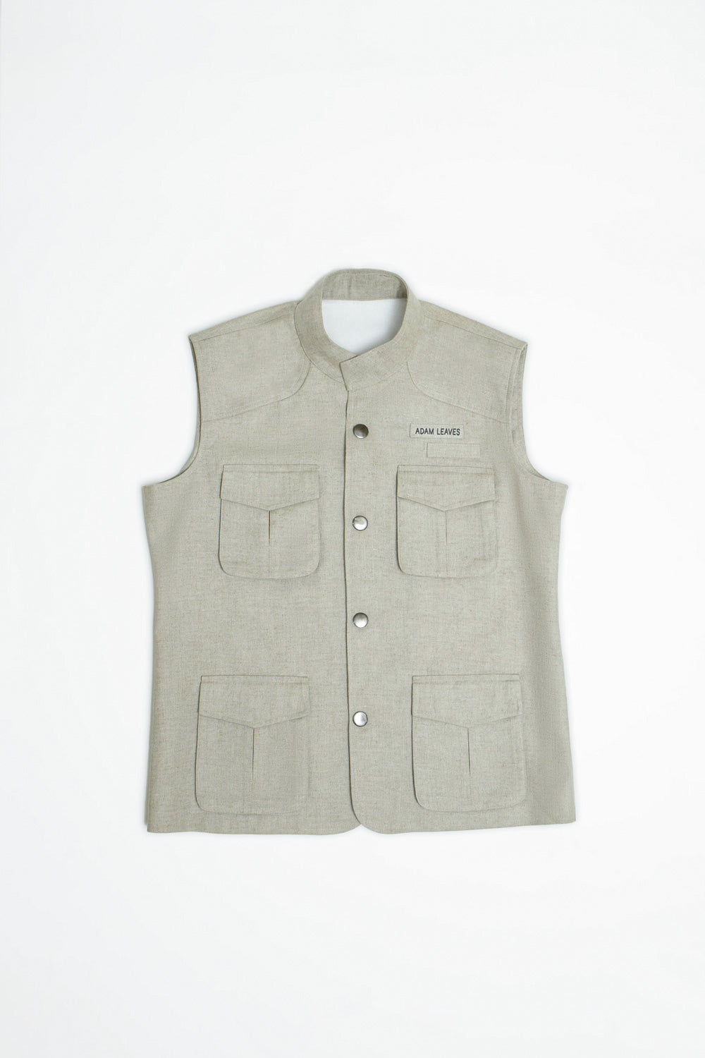 A light beige sleeveless button-up vest with four front pockets, displayed flat against a clean white background.