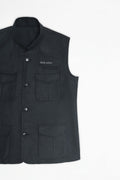Black vest with button details on a white background
