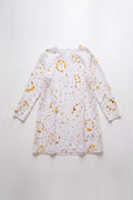 A white long-sleeve linen tunic dress with a eco-print pattern in mustard yellow, orange, and green, laid flat against a white background.