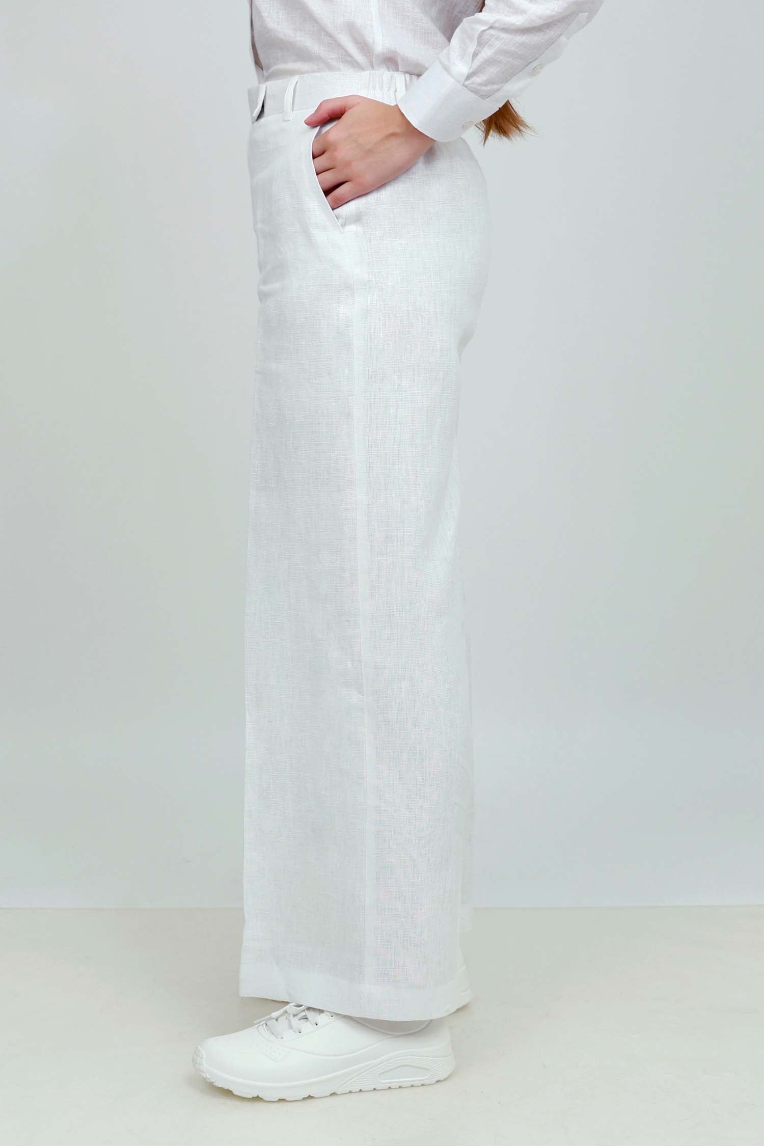 A pair of white wide-leg trousers with a mid-rise waist, front buttons, and a relaxed fit. The trousers are fully lined and have a hook and bar closure at the waistband with an adjustable elastic belt.