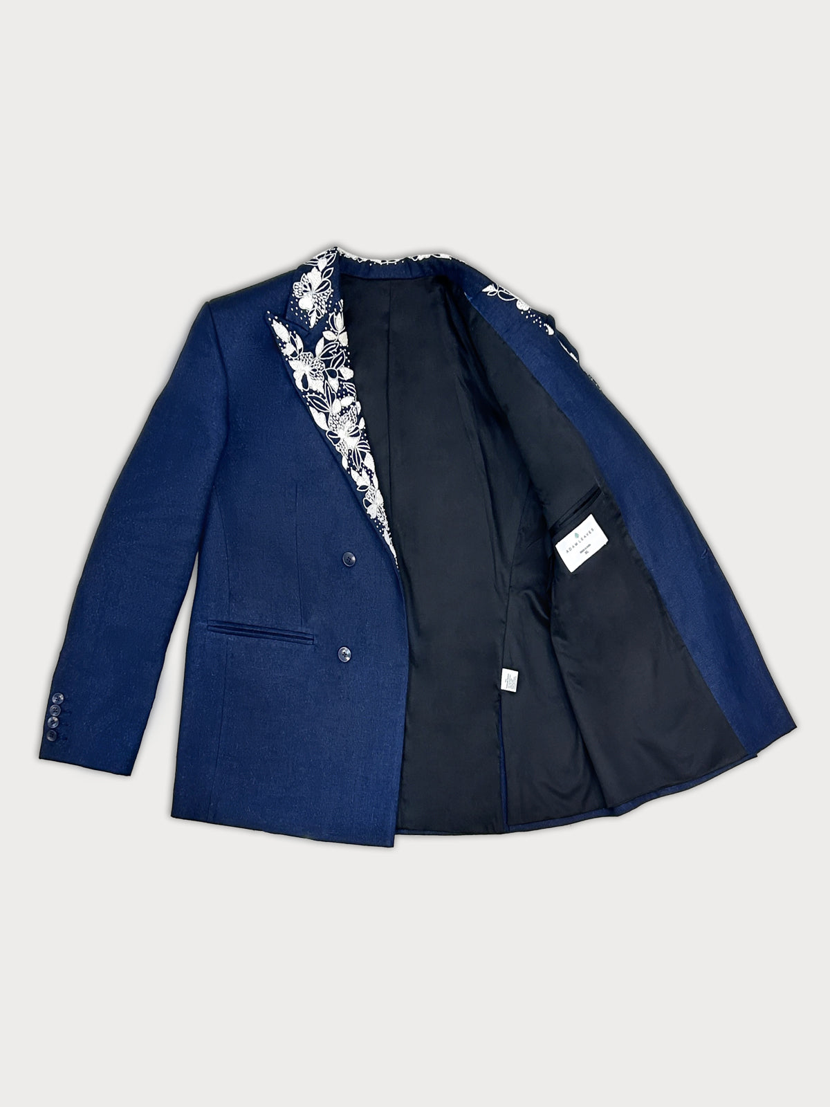 Blue blazer with floral lining on a light gray background