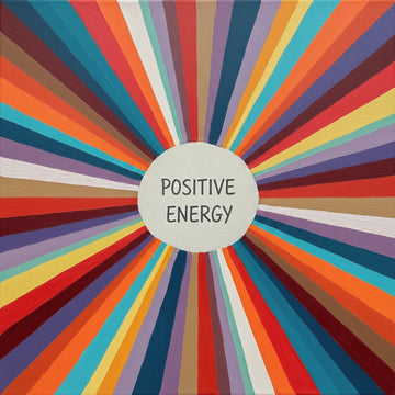 A square canvas art print featuring a vibrant sunburst pattern of radiating multicolored stripes with a central white circle containing the text 'POSITIVE ENERGY'.
