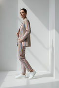 Person wearing a multicolored striped Linen suit standing against a white background