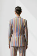 Person wearing a multicolored striped linen suit on a white background