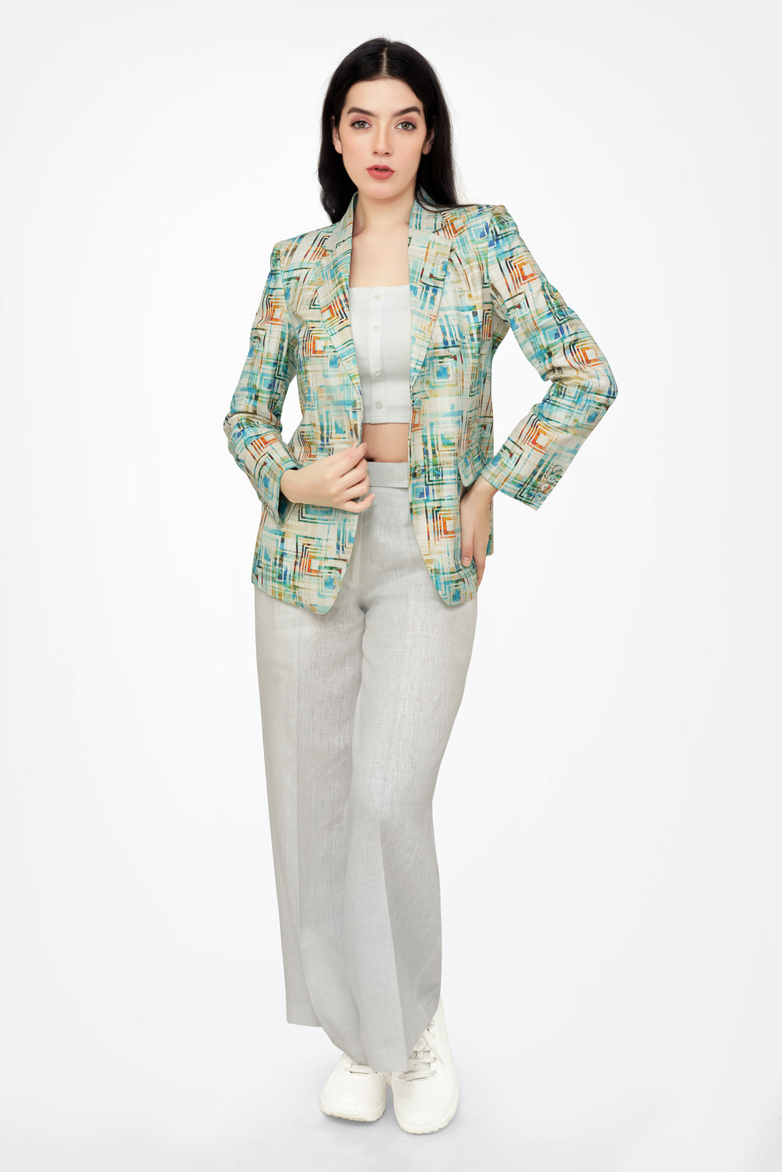 Woman wearing a patterned blazer on a white background