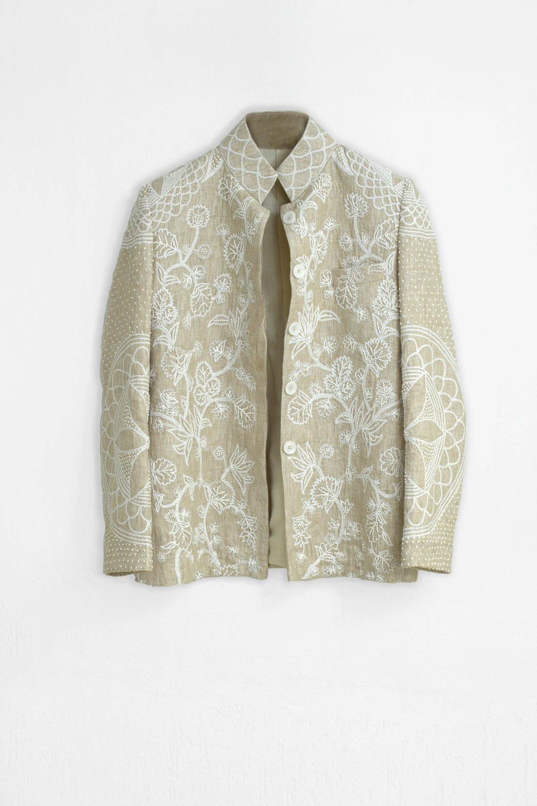 Beige floral-patterned coat on a white background