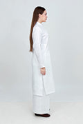 Woman wearing a white lab coat on a plain background