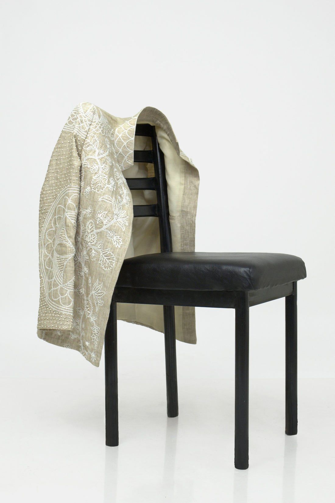 Beige floral-patterned coat on a white background