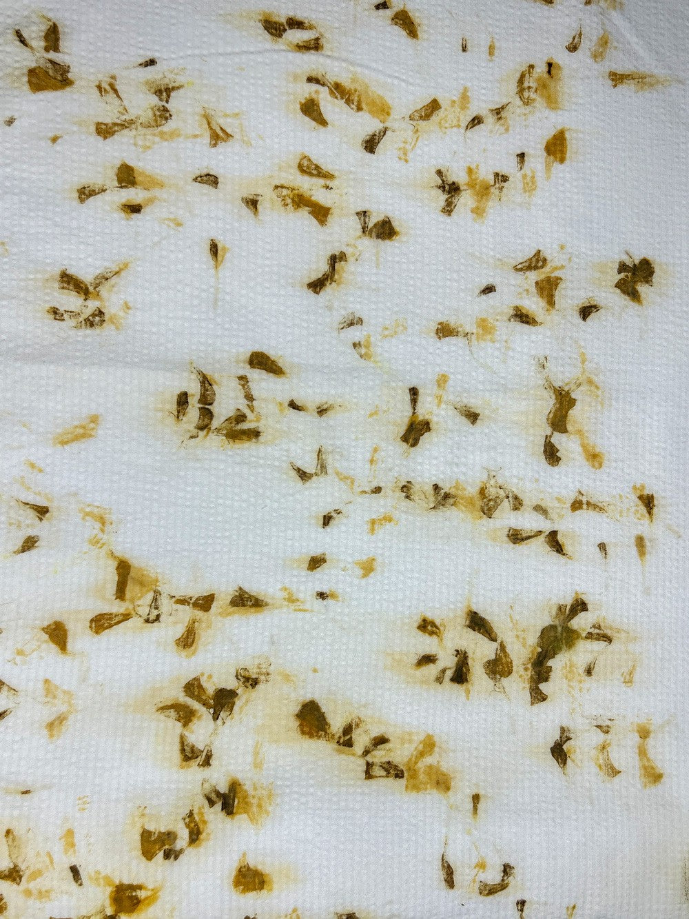 Bamboo-cotton seersucker fabric hand eco-printed with marigold petals, wide view of the print