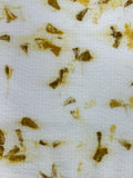 Close-up of marigold petal eco-print on bamboo-cotton seersucker fabric