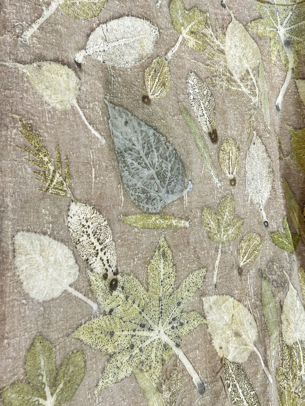Brown hemp-cotton fabric with eco-printed leaf impressions, wider view