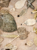 Close-up of leaf eco-print on beige hemp-cotton fabric