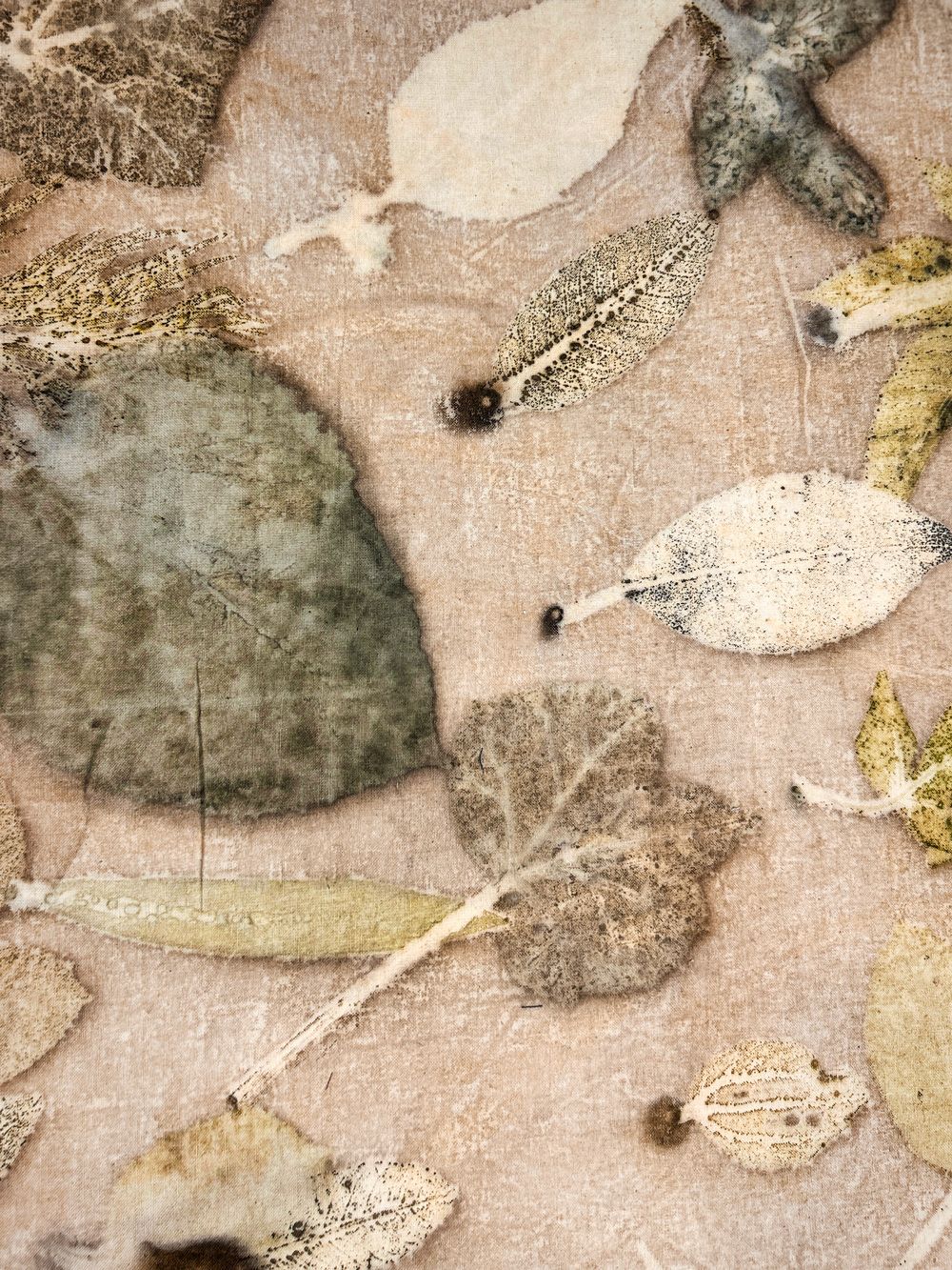 Close-up of leaf eco-print on beige hemp-cotton fabric