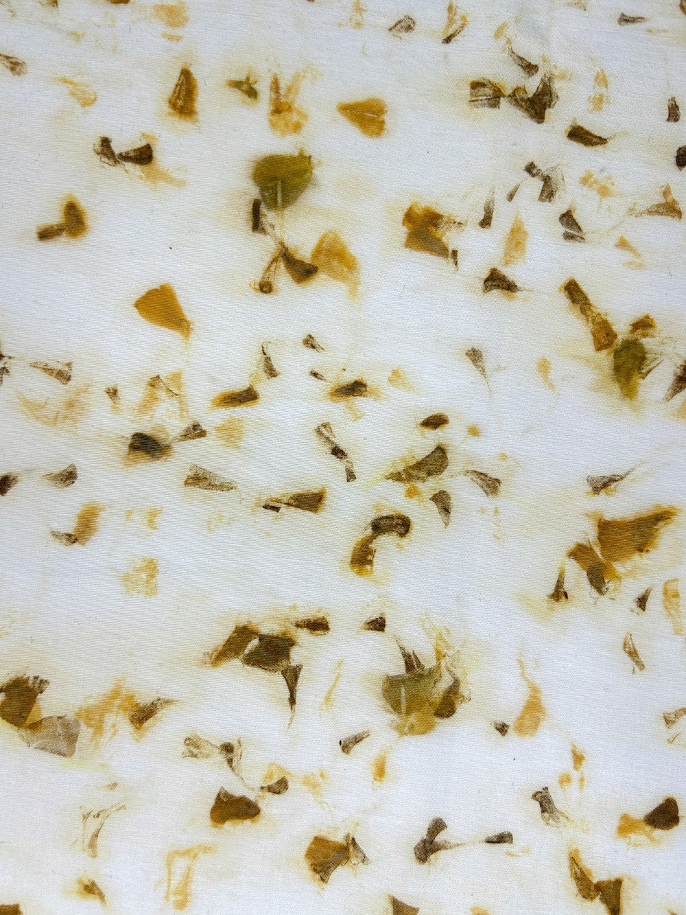 Close-up of marigold petal eco-print on hemp-cotton fabric