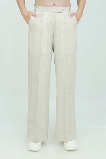 A pair of beige wide-leg trousers with a mid-rise waist, front buttons, and a relaxed fit. The trousers are fully lined and have a hook and bar closure at the waistband with an adjustable elastic belt.