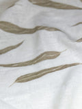 Ivory linen softly draped, showing eucalyptus leaf prints