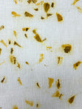 Close-up of marigold petal eco-print on linen fabric