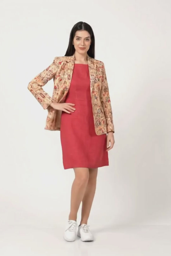 A woman modeling a two-piece outfit consisting of a solid magenta pink knee-length dress and a beige patterned linen blazer with red and gold details, paired with white sneakers, against a plain white studio background.