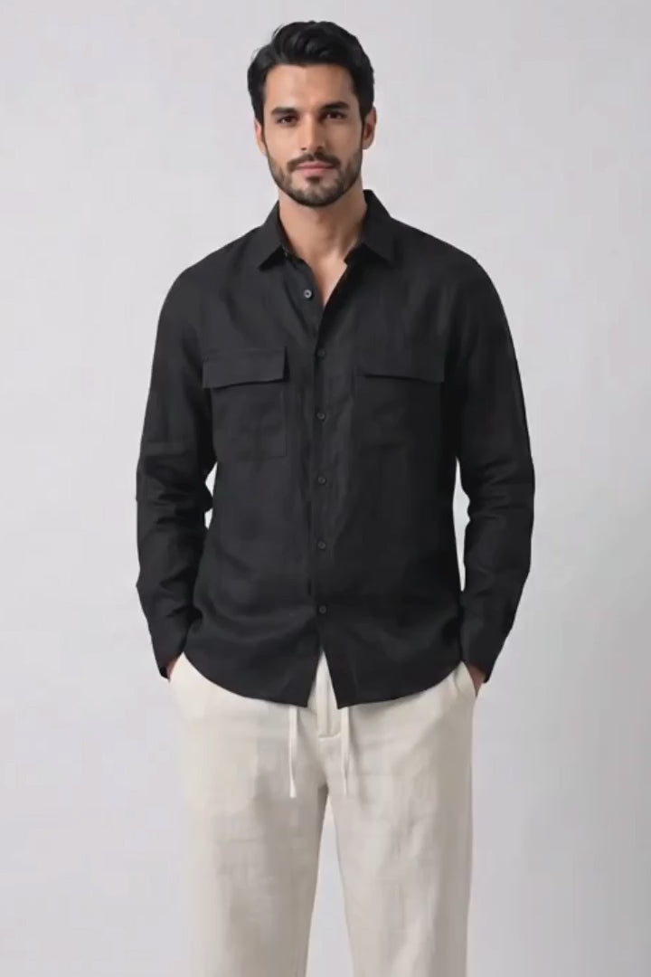 A man modeling a black long-sleeve button-up shirt and off-white hemptrousers against a plain white studio background.