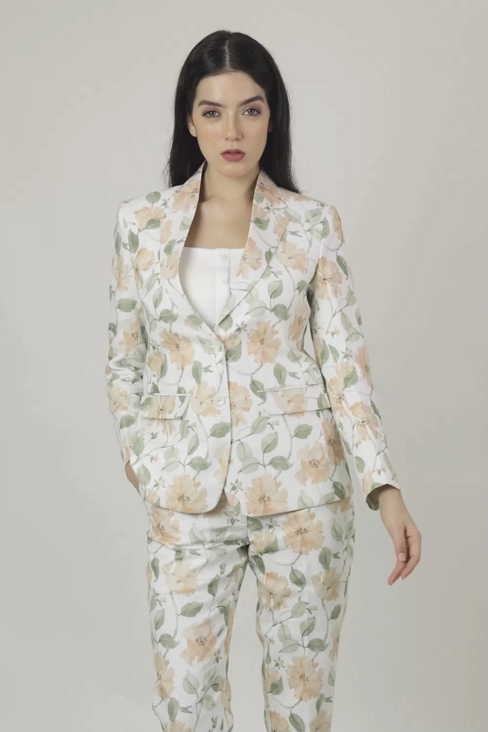 Woman wearing a floral suit on a white background
