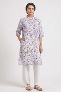 A model wearing a lavender cotton eco-print kurta featuring natural marigold leaf motifs in earthy golden tones. The straight-fit kurta has a mandarin collar, three-quarter sleeves, a short button placket, and side pockets. It is paired with off-white straight pants and white braided sandals against a clean white background.